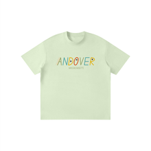 Load image into Gallery viewer, A light mint green crewneck t-shirt with 'ANDOVER MASSACHUSETTS' printed across the chest in a colorful, hand-drawn style. The letters feature various colors like orange, yellow, blue, and red, with the 'O' designed as a red heart.