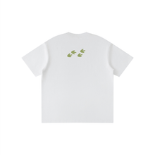 Load image into Gallery viewer, A white short-sleeve t-shirt shown from the back, featuring a small graphic of four green leaf-like shapes arranged in a row near the upper back.