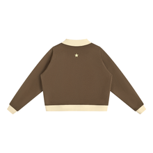 Load image into Gallery viewer, A cropped long-sleeve sweatshirt shown from the back, featuring a solid brown body with contrasting cream-colored collar, cuffs, and hem.