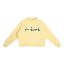 Load image into Gallery viewer, A pale yellow long-sleeve crewneck sweatshirt with the word 'Andover' embroidered in dark blue cursive across the chest, displayed on a clean white background.
